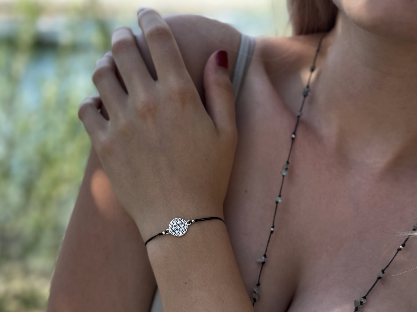 Bracelet made of silver beads with small flowers 