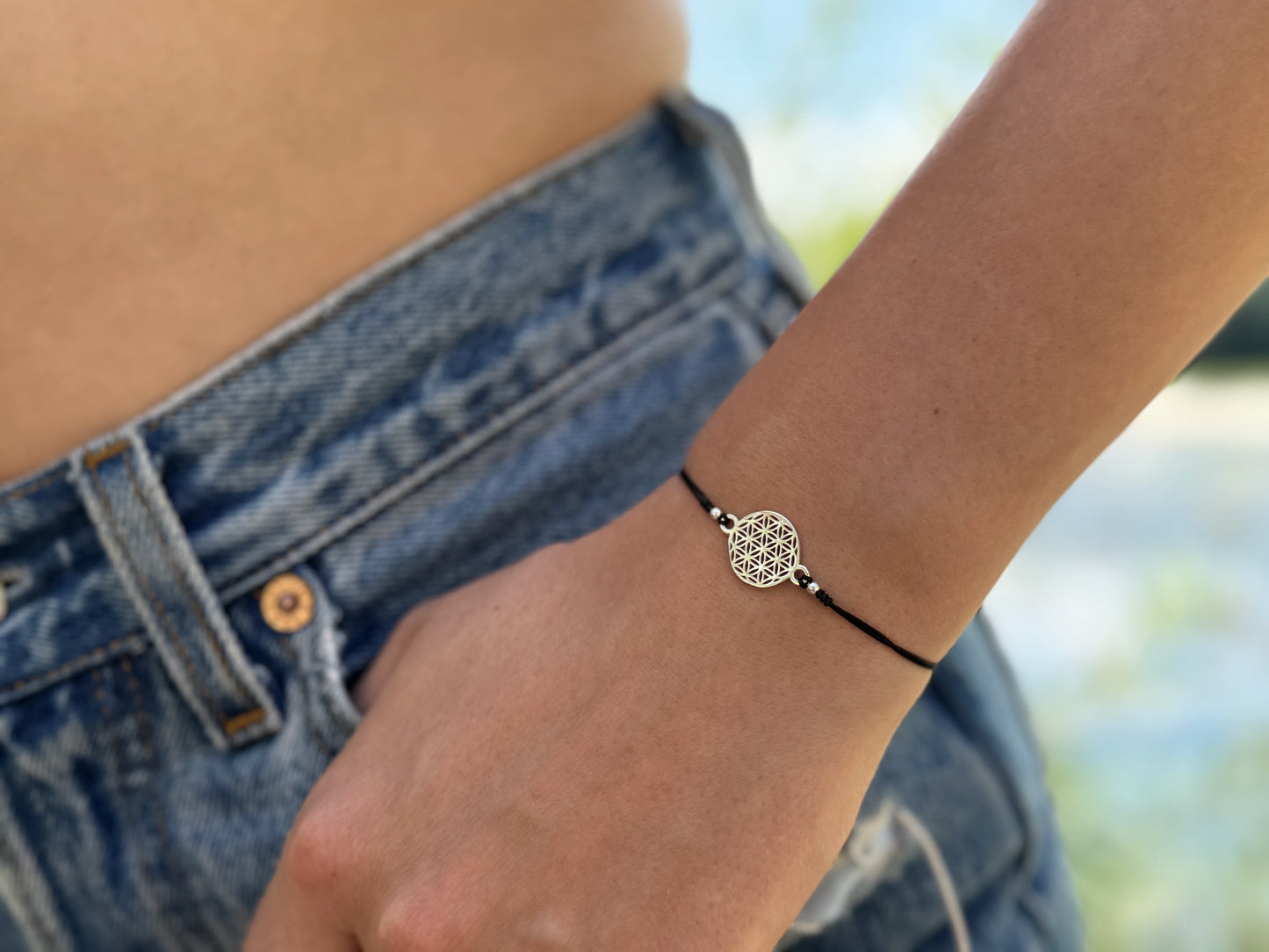 Bracelet made of silver beads with small flowers 