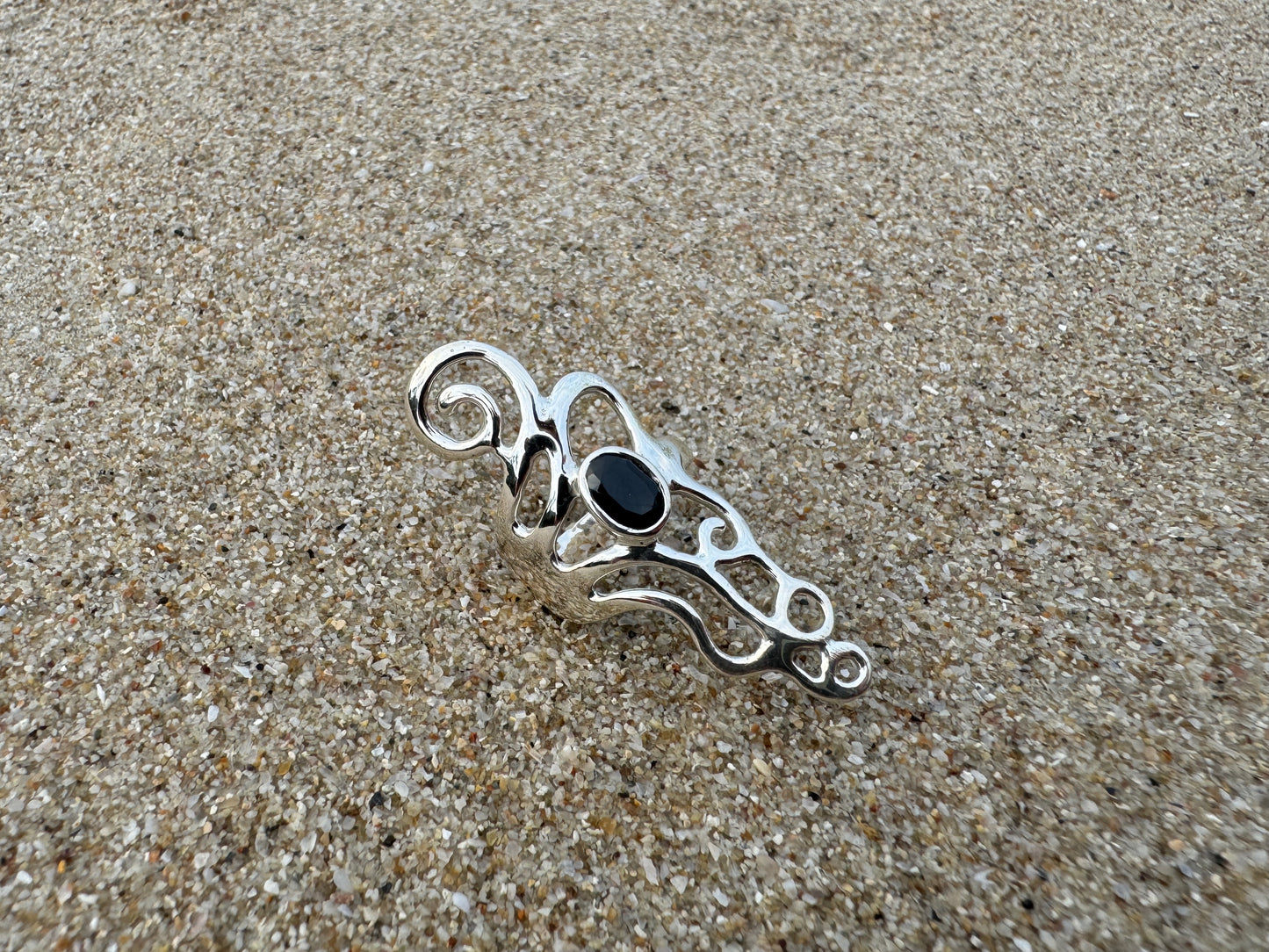 Ornate silver ring with spirals and black stone 