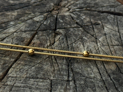 double row anklet made of colored beads and spirals 