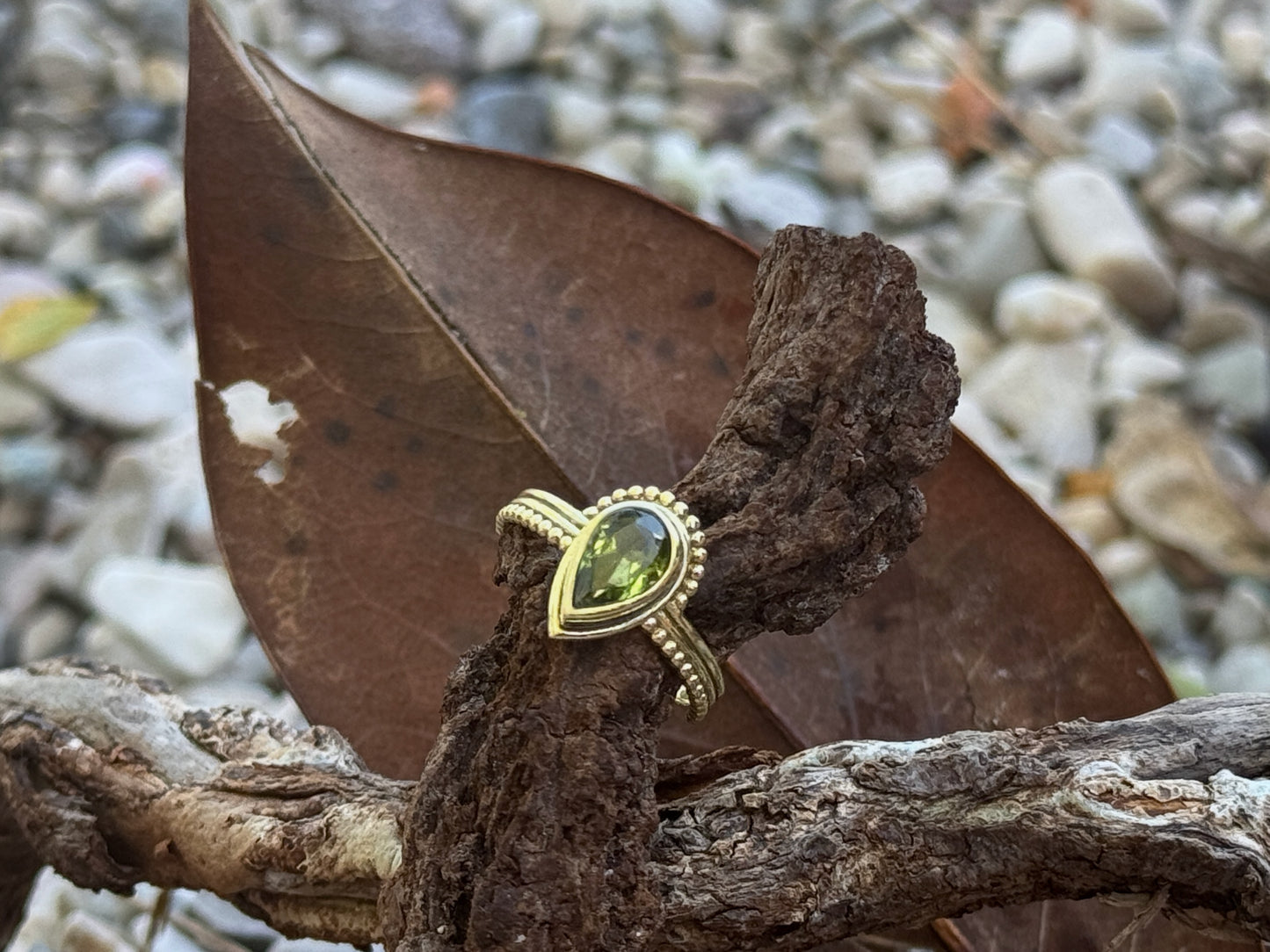 Brass ring with teardrop-shaped turquoise stone 