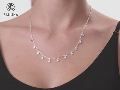 Necklace with small dangling round silver pendants 