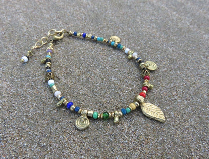 colorful bracelet with small pendants and brass beads
