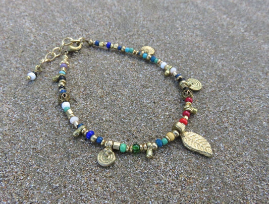 colorful bracelet with small pendants and brass beads
