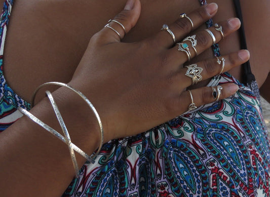 three intertwined hammered silver bangles 