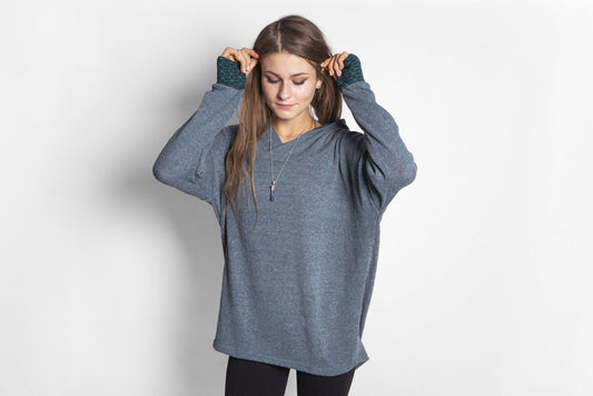 long knitted sweater with a patterned hood and thumbholes in blue 