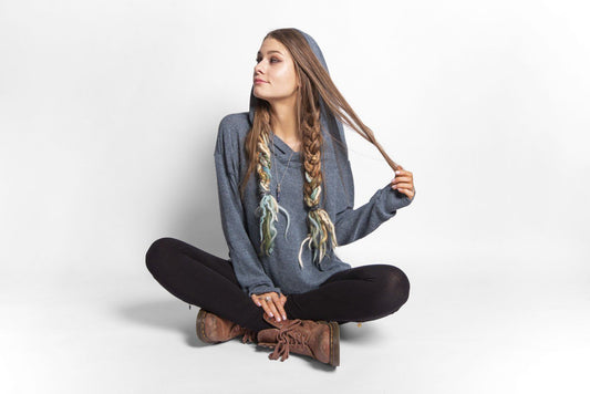 long, plain knitted sweater with a large hood and thumbholes in blue 