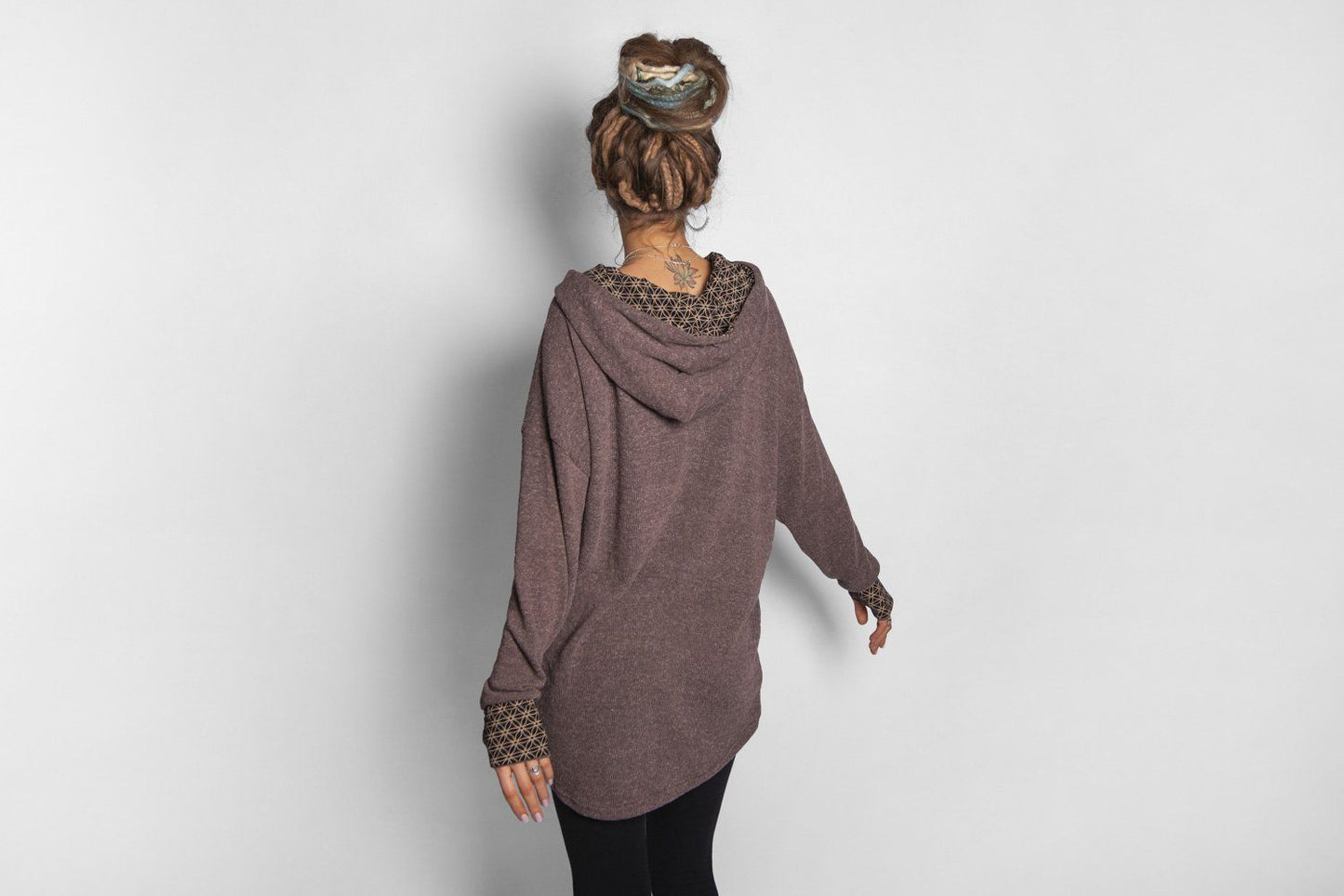 long knitted sweater with a patterned hood and thumb holes in brown 