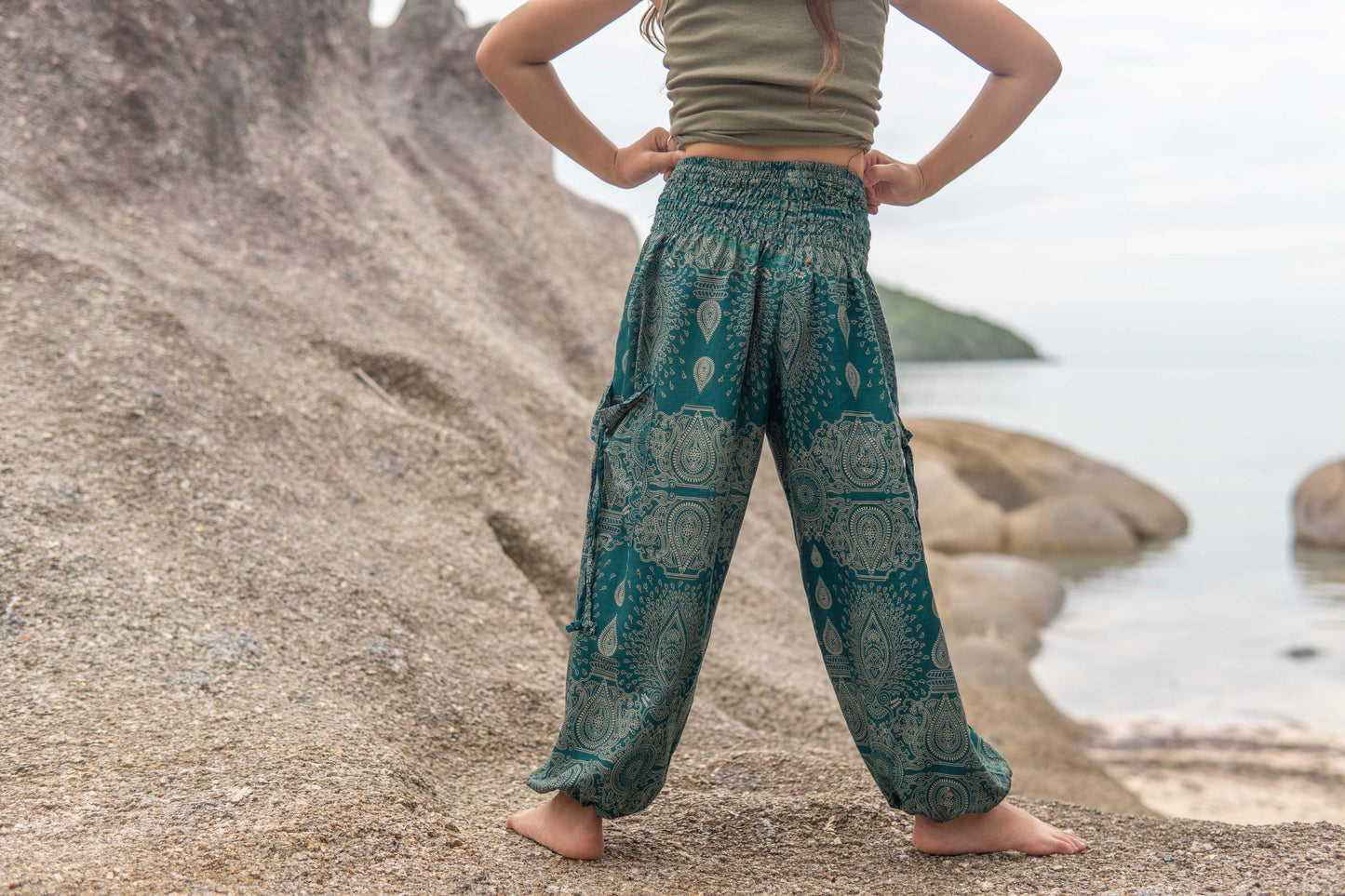 Airy turquoise harem pants with a delicate pattern for children 