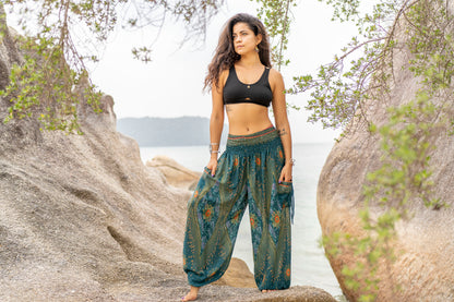 Airy harem pants with a peacock pattern in turquoise