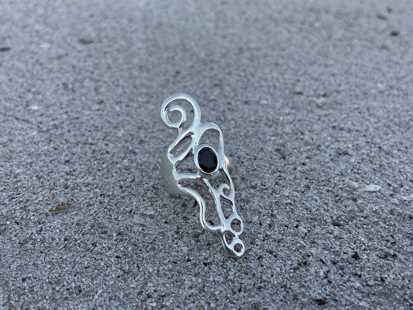 Ornate silver ring with spirals and black stone 