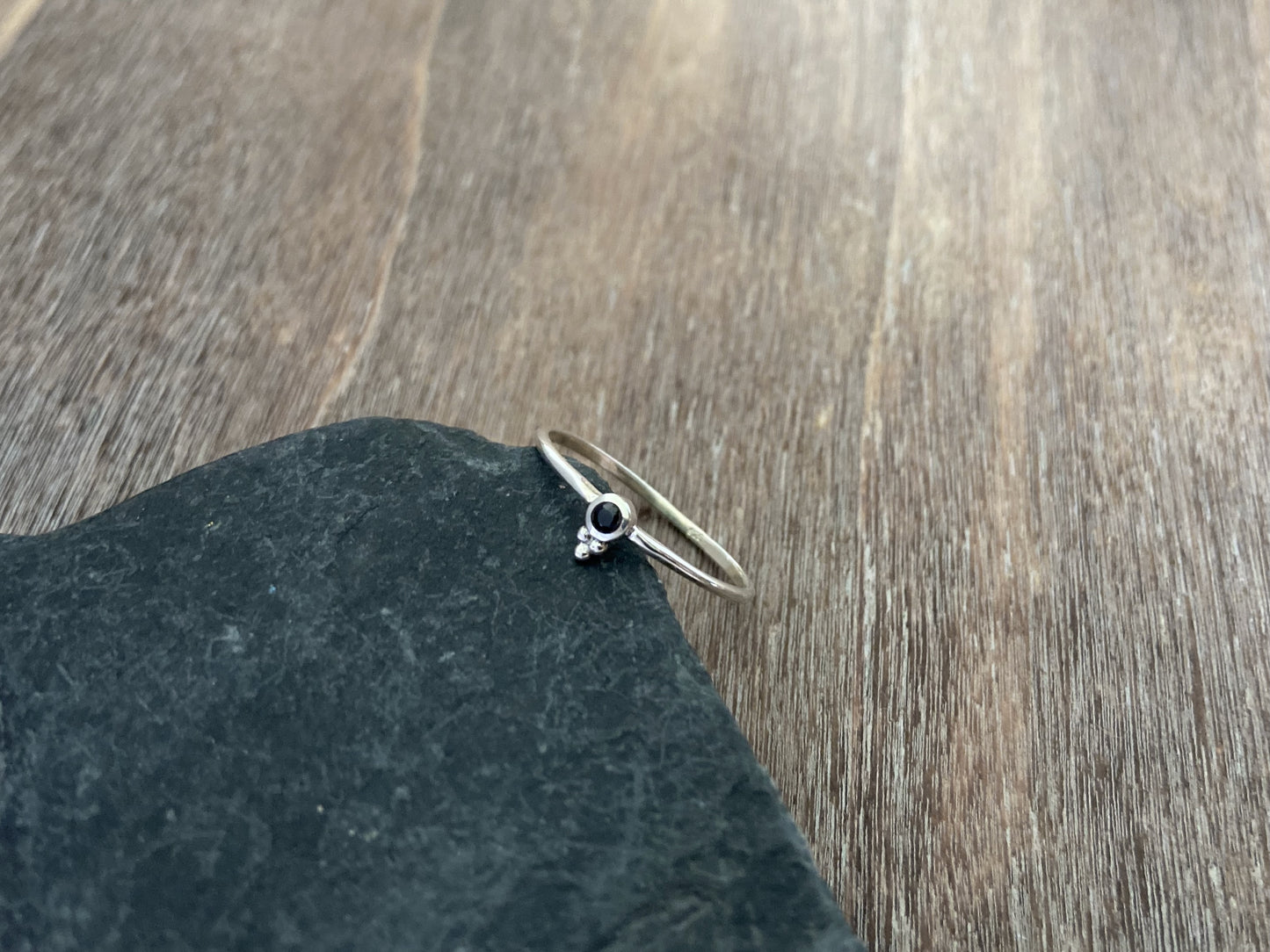 Dainty silver ring with a small faceted black spinel stone and three beads 