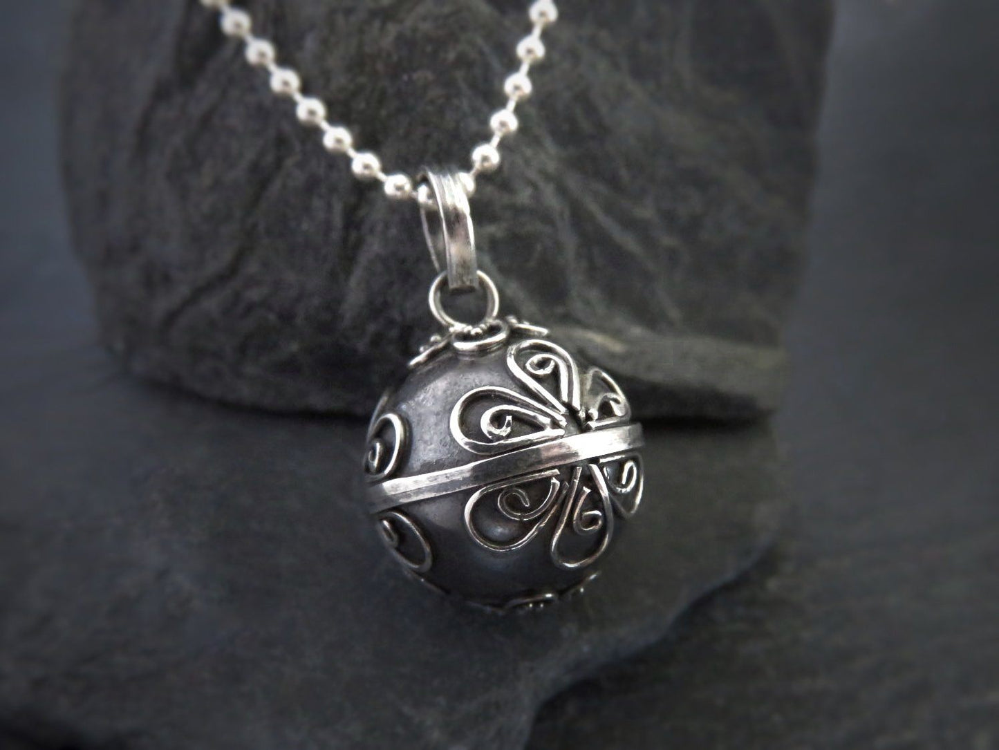 small sound ball made of silver decorated with spirals 