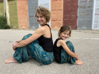 Airy turquoise harem pants with a delicate pattern for children 