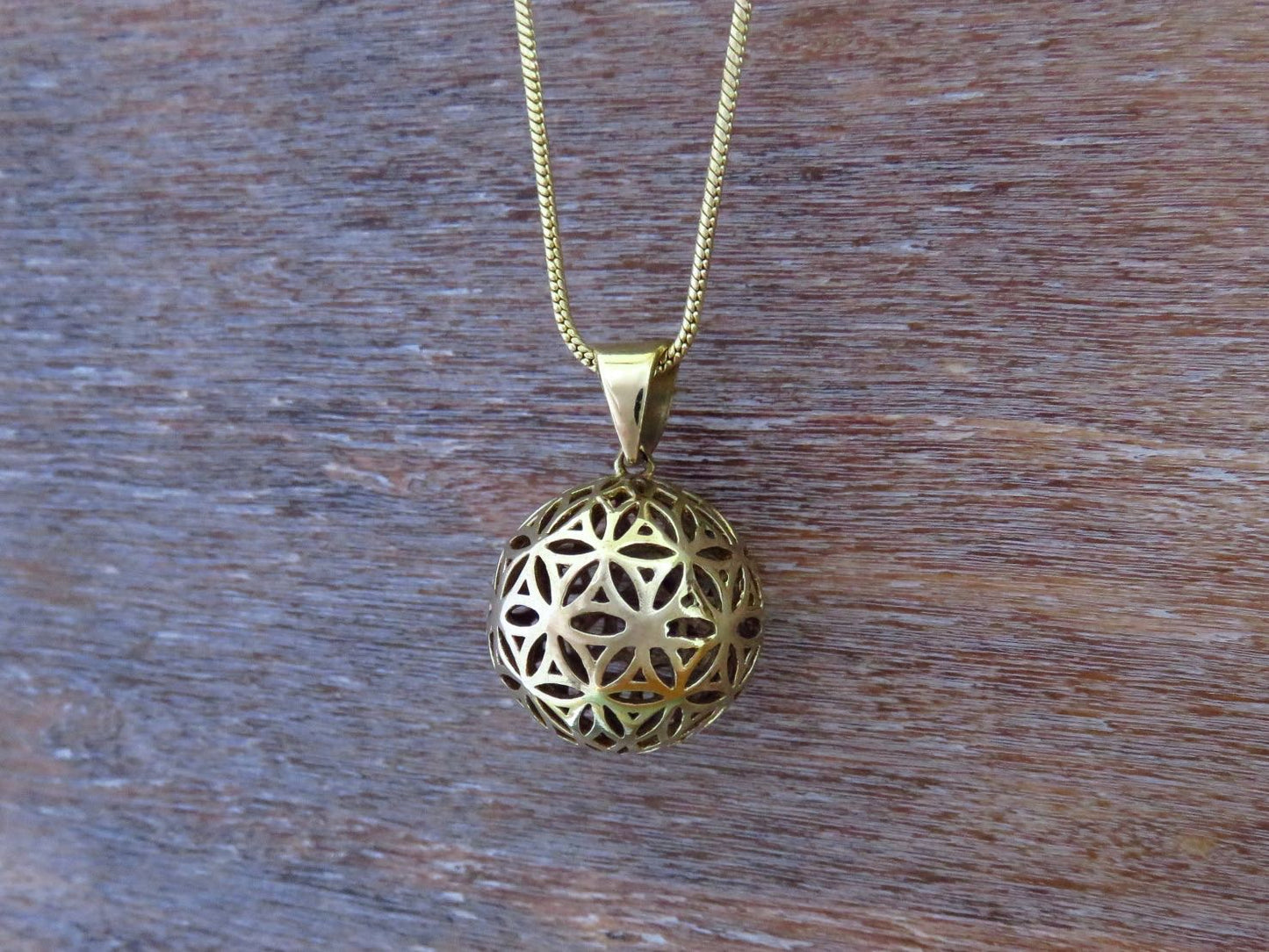 Ball pendant with the motif of the flower of life made of brass 
