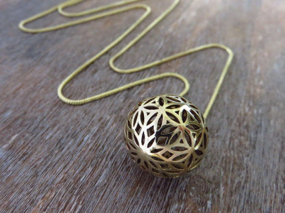 Ball pendant with the motif of the flower of life made of brass 