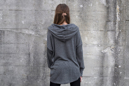 long knitted sweater with a patterned hood and thumbholes in gray 