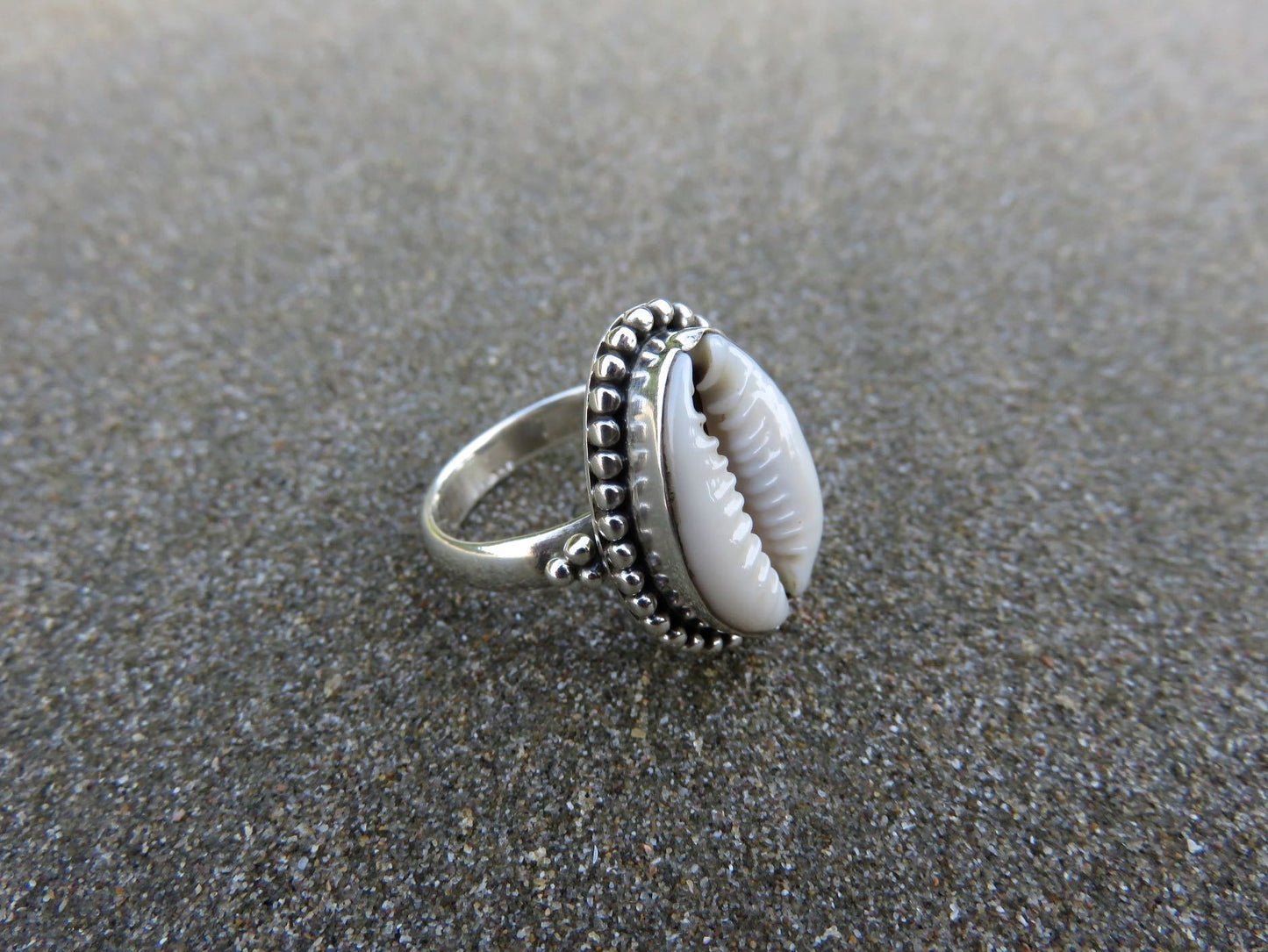Ring with cowrie shell decorated with small silver beads 