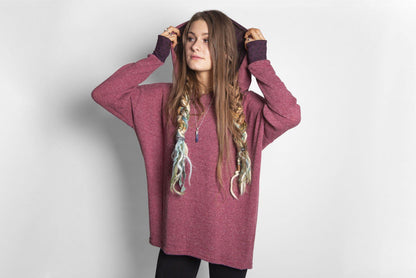long knitted sweater with a patterned hood and thumb holes in rose red