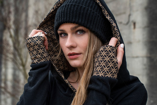 long knitted sweater with a patterned hood and thumbholes in black 