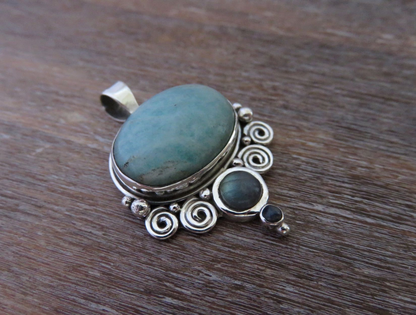Pendant with spirals and stones made of silver