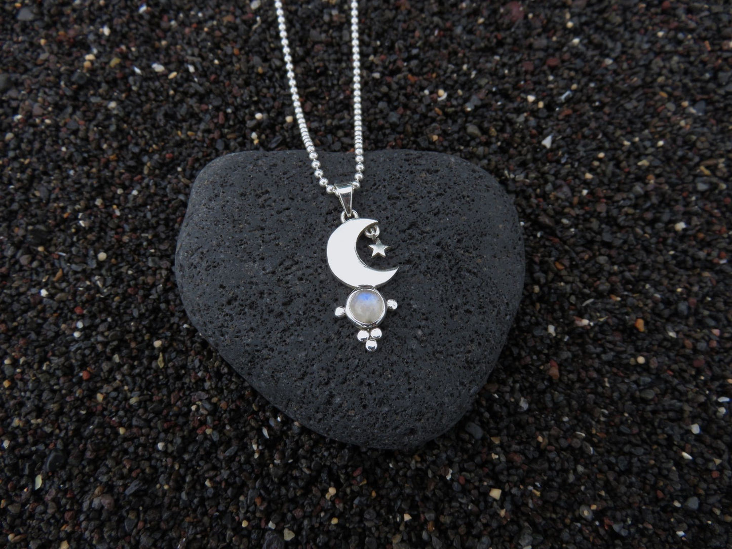 small pendant with moon and stars on a silver ball chain 