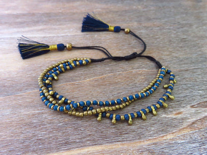 adjustable brass bracelet in black or blue with tassels 