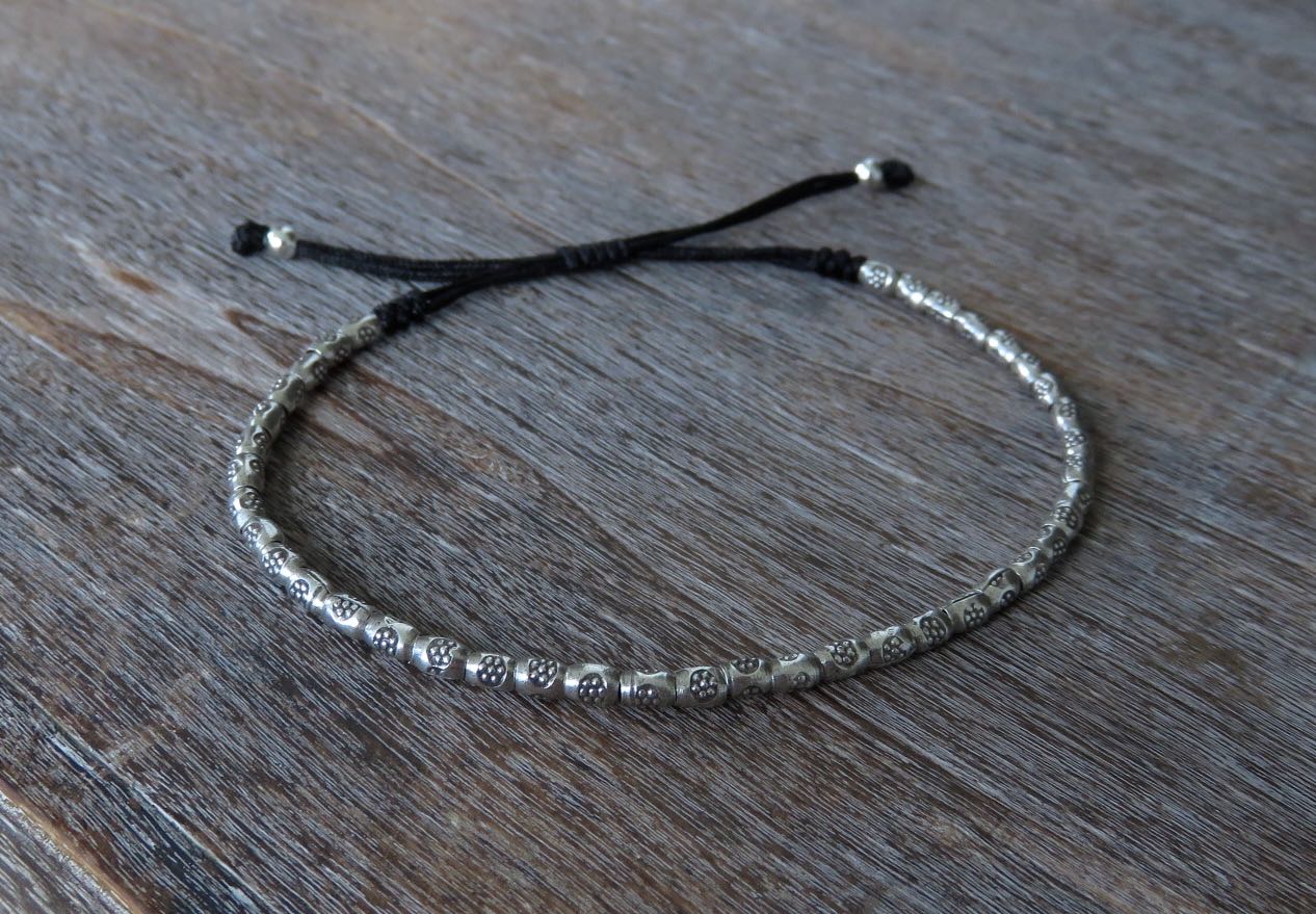 Bracelet made of silver beads with small flowers 