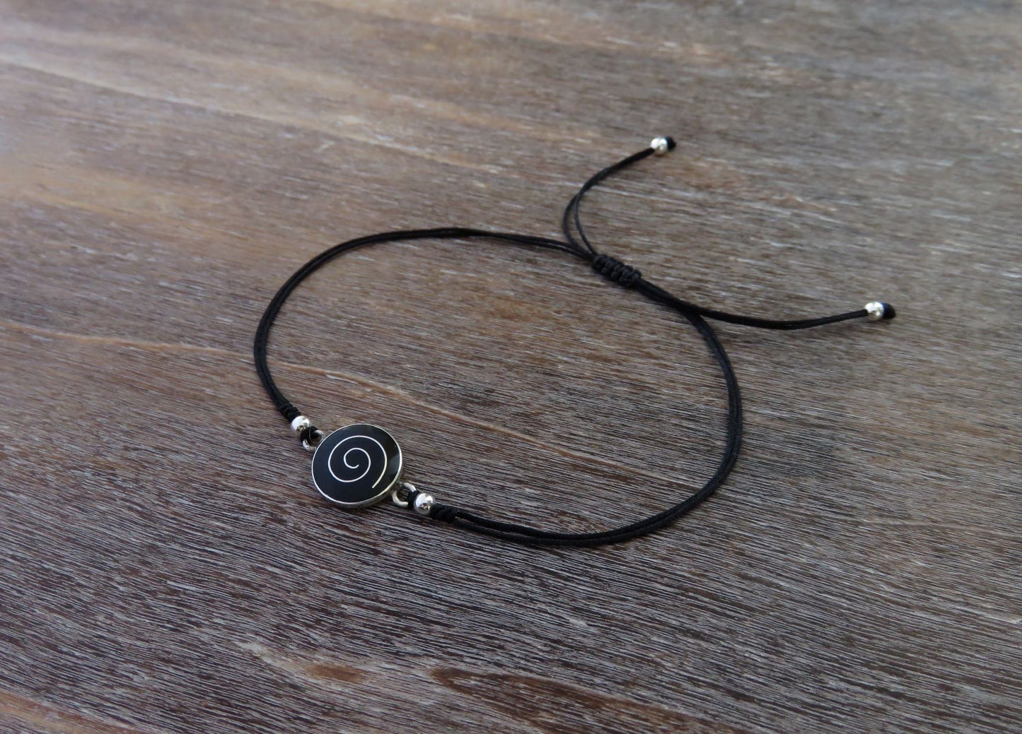black bracelet with spiral and silver beads 