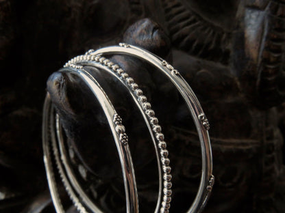 Set of three decorated silver bangles 