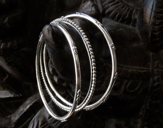 Set of three decorated silver bangles 