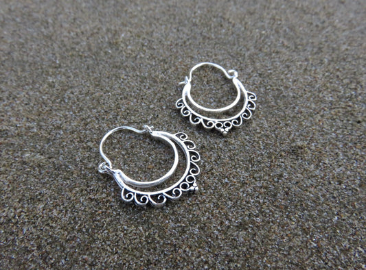 small hoop earrings with a filigree spiral pattern made of silver 