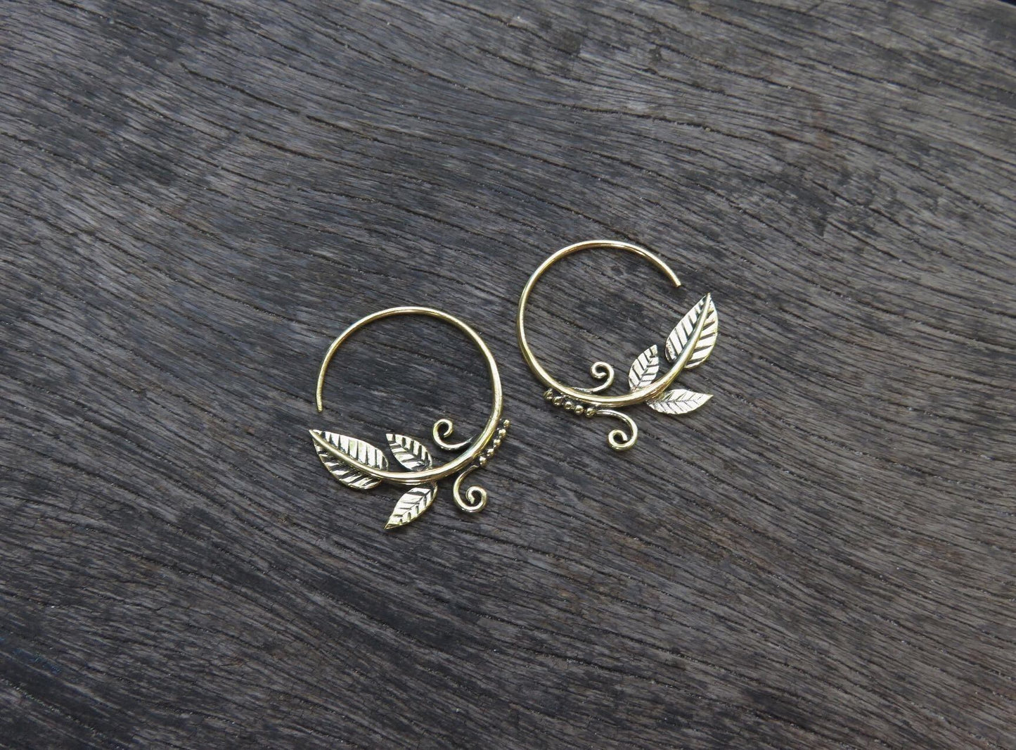 small hoop earrings with leaves and spirals made of brass 