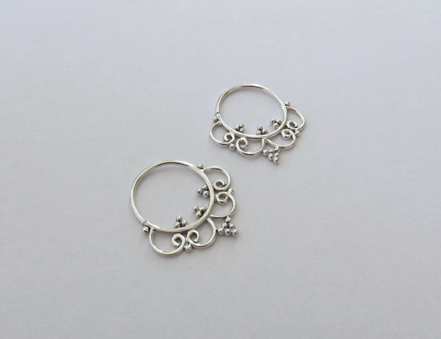 small hoop earrings decorated with dots and spirals made of silver