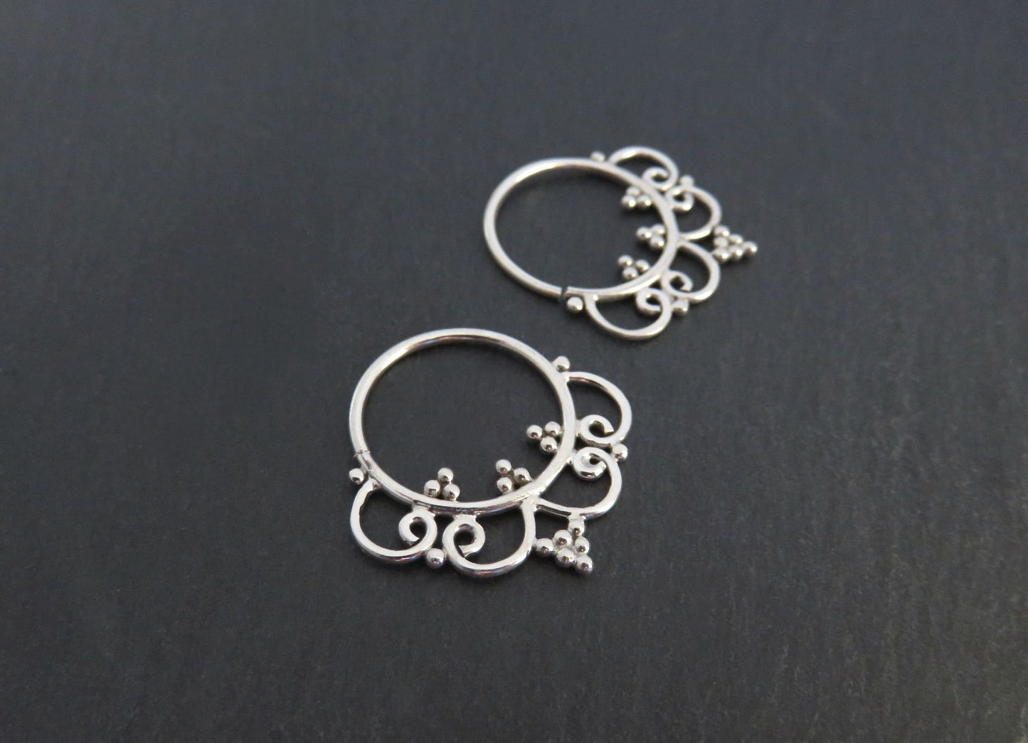 small hoop earrings decorated with dots and spirals made of silver