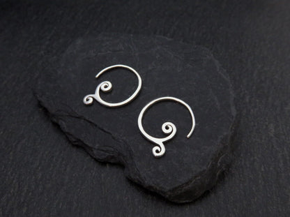 simple small earrings with spirals made of silver 