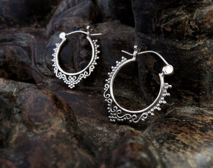 small hoop earrings decorated with spirals and dots made of silver