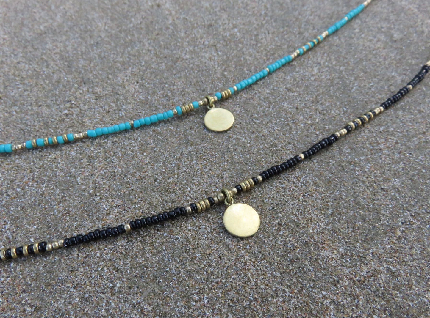 Anklet with a small round brass pendant 