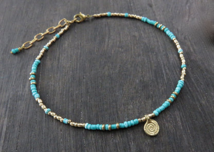Anklet with a small spiral pendant made of brass 