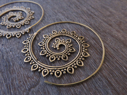 large spiral earrings with a filigree pattern made of brass 