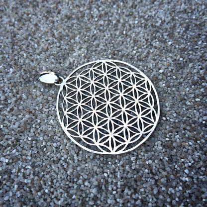 large pendant with the motif of the flower of life made of silver 