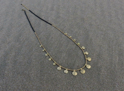 long necklace with brass spirals and black beads 