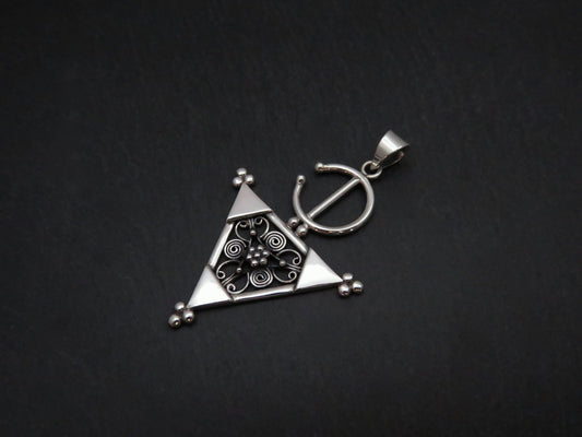 Pendant with a filigree decorated triangle made of silver 