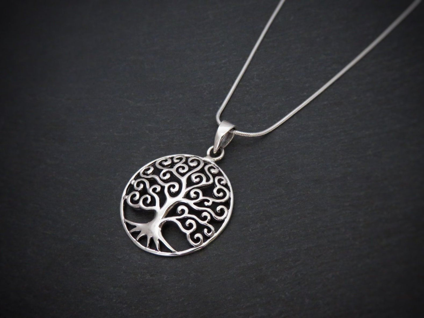 Domed pendant with the motif of the tree of life made of silver 