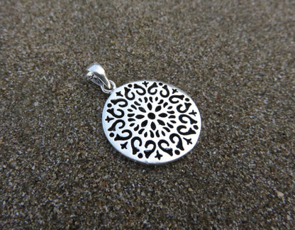 small round pendant on a silver ball chain 