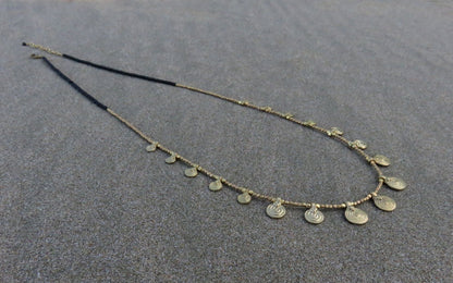 long necklace with brass spirals and black beads 