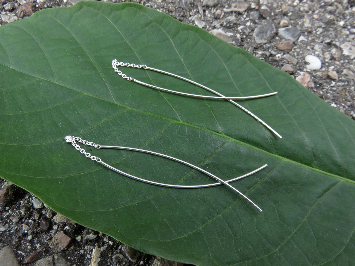 Earrings with chain and dangling silver pins 