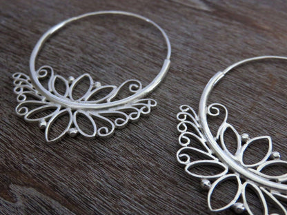 large hoop earrings with lotus flower motif made of silver 