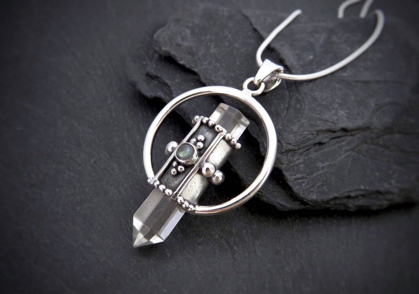 Rock crystal pendant with small stone made of silver 